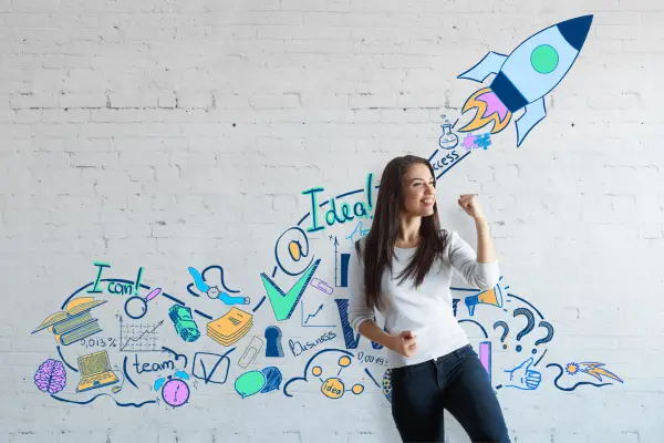 IMAGE OF WOMEN INFRONT OF A WALL WITH IDEAS ON IT