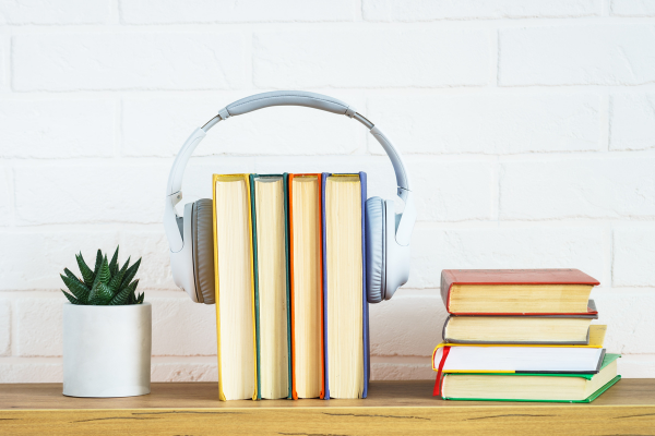 PHOTO OF BUSINESS BOOKS AND HEADPHONES