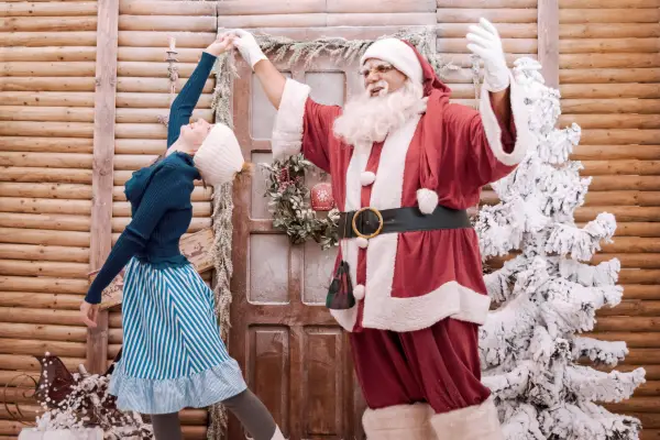 Santa dancing with a girl